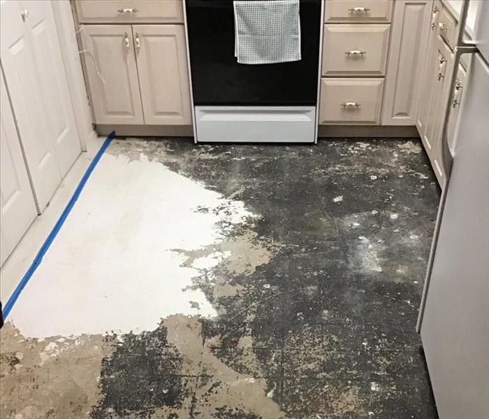kitchen floor stripped of flooring showing pad