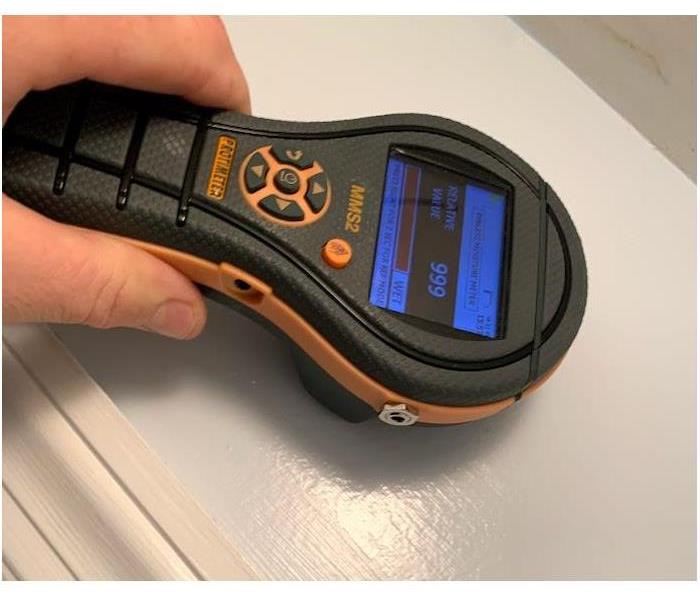 Moisture detection equipment held by SERVPRO technician