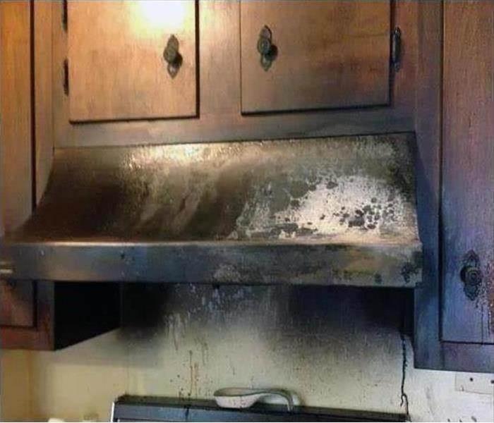 A stove top covered in grease after a fire