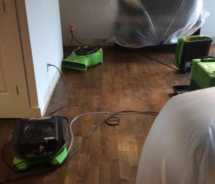 SERVPRO equipment on the floor in a room. 