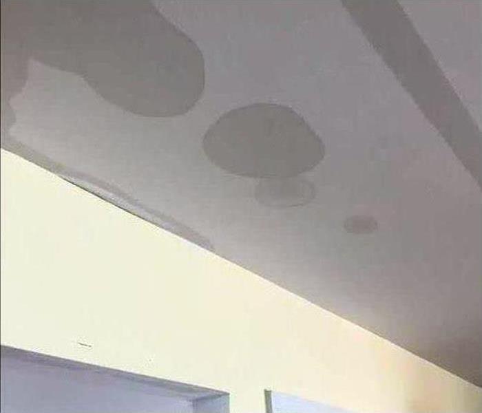 A ceiling with water stains after a flood