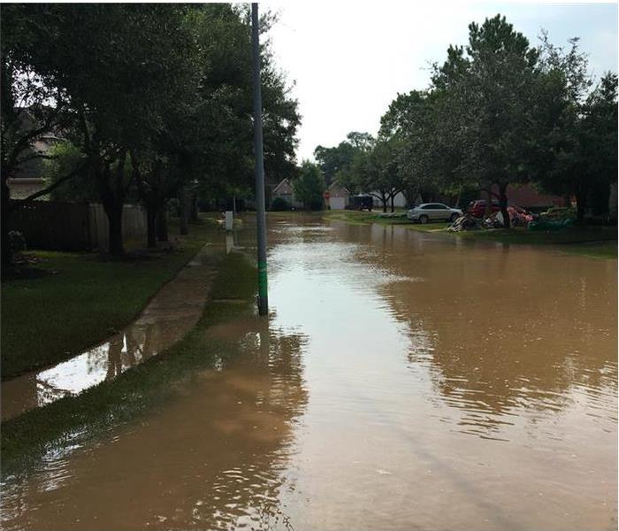 Flooded street; water covering sidewalk