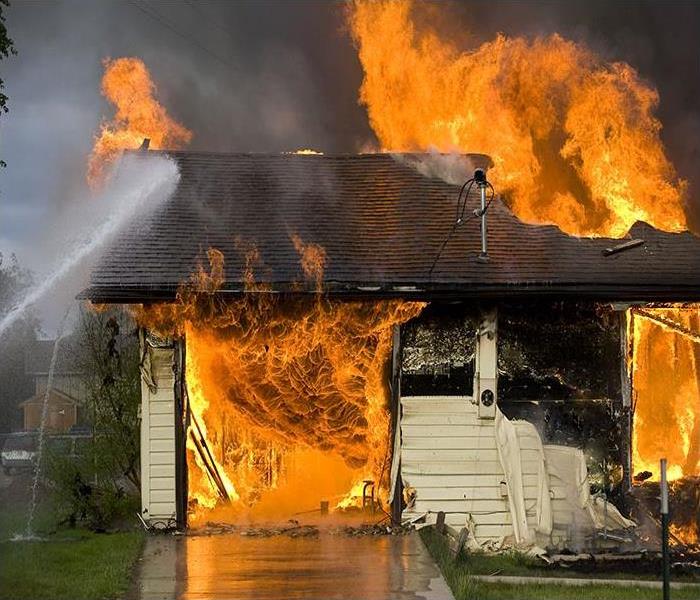 Firemen Putting Out a House Fire Disaster